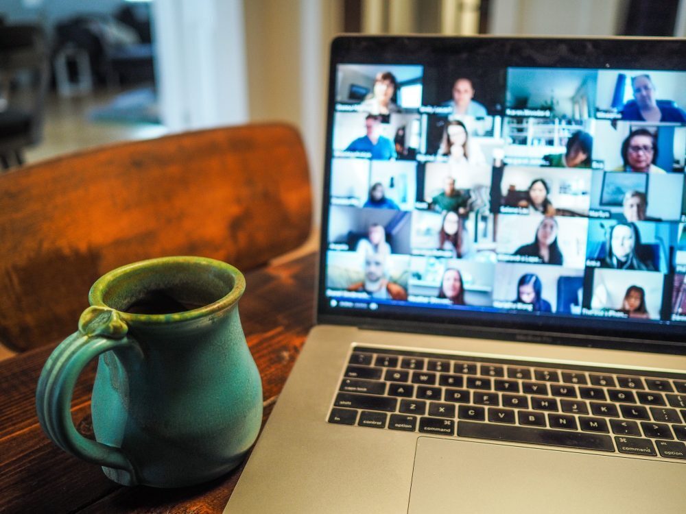 photograph of a laptop being used for a conference call with a mug of tea